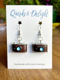 the earrings are brown and blue with stars on them