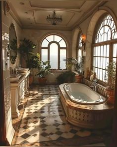 an ornate bathroom with a large jacuzzi tub in the center and windows overlooking the ocean