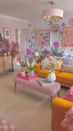 a living room filled with lots of furniture and flowers on top of the couches