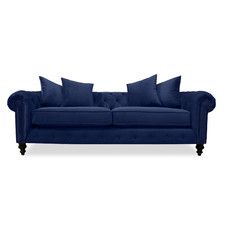 a blue couch with pillows sitting on it's back legs and armrests