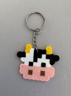 a keychain with an image of a cow in the shape of a cow