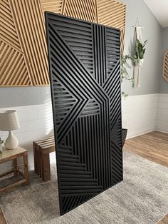 a large black door in the middle of a room