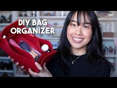 a woman holding up a red purse with the words diy bag organizer on it