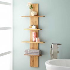 a bathroom with blue walls and wooden shelves