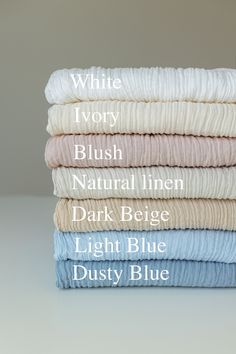 four sheets stacked on top of each other with the names of them in white, ivory, blush, natural linen, dark beige, light blue and dusty blue