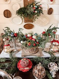 a table topped with christmas decorations and plates