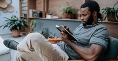 a man sitting in a chair reading a book