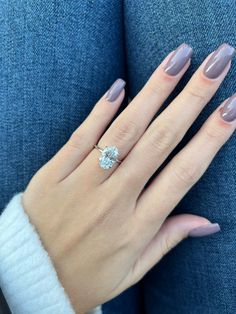 a woman's hand with a ring on it and a manicured nail polish