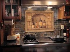 a stove top oven sitting inside of a kitchen next to wooden cupboards and cabinets