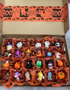 a box filled with lots of halloween figurines