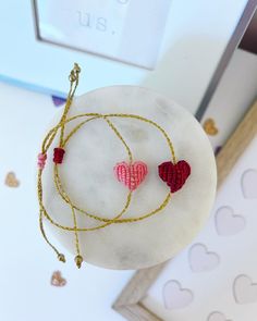 This set of wax thread macrame beaded Valentine heart bracelets are the perfect gift for Valentine's Day morning! Dainty and colorful, they can be worn every day as a reminder of the love the have from you! There is a box to add any personalization changes or text changes! With your purchase you receive: 1 Personalized card 1 Red Heart AND 1 Pink Heart wax thread macrame beaded bracelet (adjustable) 1 Box & Ribbon (31/2 x 31/2 x 1 inch box) Color of your choice! THE LOVE LEIGH GIFT PROMISE: Our Handmade Pink Braided Bracelets As Gifts, Pink Beaded Bracelets With Adjustable Cord As Gift, Pink Adjustable Beaded Bracelets For Gifts, Adjustable Beaded Bracelets With Heart Charm For Valentine's Day, Valentine's Day Adjustable Handmade Beaded Bracelets, Handmade Adjustable Beaded Bracelets For Valentine's Day, Valentine's Day Friendship Bracelets With Heart Beads, Pink Braided Bracelet With Adjustable Cord As Gift, Heart-shaped Friendship Bracelets With Sliding Knot For Valentine's Day