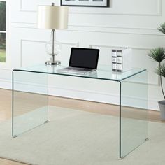 a glass desk with a laptop on it