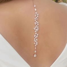 Make a statement on your special day with our exquisite bridal choker backdrop necklace. Crafted with high-quality materials, this piece is designed to elevate your bridal ensemble and add a touch of glamour to your look. Key Features: Made with zinc alloy and adorned with cubic zirconia, rhinestones, and simulated pearls for a luxurious appeal Body chain/back necklace chain material crafted from alloy and cubic zirconia crystal for a dazzling effect Exudes elegance and sophistication, making it Glamorous Silver Backdrop Necklace For Wedding, Glamorous Backdrop Necklace For Weddings, Silver Cubic Zirconia Backdrop Necklace For Wedding, Delicate Dangle Backdrop Necklace For Wedding, Silver Delicate Backdrop Necklace For Wedding, Back Necklace Wedding, Bridal Backdrop Necklace, Backdrop Necklace, Backdrops Necklace