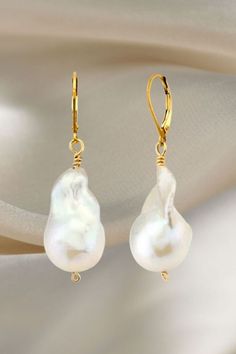 Elevate your style with these timeless pearl earrings that effortlessly complement any outfit, day or night! From laid-back chic to glamorous affairs, these pearl earrings are your go-to accessory for every look. Embrace their versatility and embrace your own style! ✨ Baroque Pearl Teardrop Earrings With High Luster, Classic Baroque Pearl Drop Earrings, High Luster Baroque Pearl Teardrop Earrings, Classic Baroque Pearl Earrings In Pearl White, Handmade Baroque Pearl Earrings In Pear Shape, Handmade Baroque Pearl Pear-shaped Earrings, Gold Baroque Pearl Pear-shaped Earrings, Handmade Pear-shaped Baroque Pearl Earrings, Baroque Pearl Earrings With Pearl Charm For Anniversary