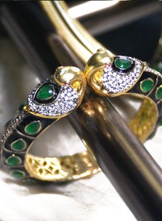 Haritah - Cuff Bracelet with Green Onyx & CZ stones Stone Setting: Onyx & CZ stones Finish: Gold Plated Composition: Metal Alloy Statement cuff bracelet adorned with beautiful green Onyx teardrop gemstones. Furthermore, this statement women's cuff bracelet has a gold plated swan structure accented with minimal CZ stones and ruby eye detail. Green Onyx women's cuff bracelet is adorned with CZ stones at the top end of this statement alloy cuff. *Please chat with us for customization reques Green Bangle Cuff Bracelet For Party, Green Stone Bracelets For Party, Green Jeweled Bangle Bracelets, Elegant Green Bangle With Stone Work, Stone Bangle Bracelets For Parties, Stone Bangle Bracelet For Party, Green Jeweled Bangle Bracelet, Elegant Green Bangle Cuff Bracelet, Green Cuff Bracelet For Party