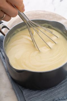 a person whisking batter into a skillet