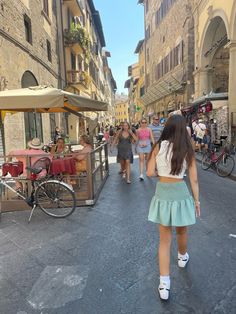 people walking down the street in an old town