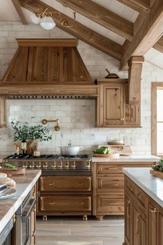 a large kitchen with wooden cabinets and white marble counter tops is pictured in this image