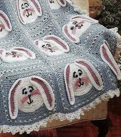 a crocheted blanket with bunny ears on it