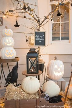 pumpkins and other decorations on display in front of a house