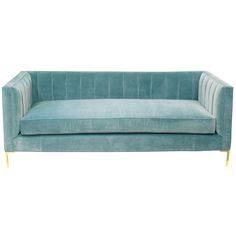 a blue velvet couch with gold legs