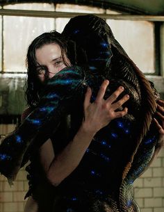 a man and woman hugging in a room with brick walls, blue lights on them