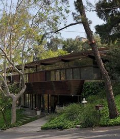 the house is surrounded by trees and greenery