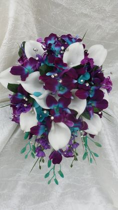 the bridal bouquet is purple and white