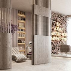 a living room filled with lots of furniture and flowers on the wall next to a window