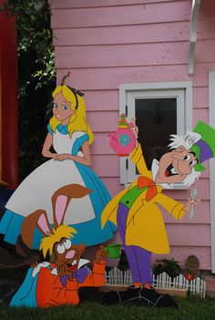 two cartoon characters standing in front of a pink house