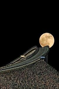 a full moon is seen over a road