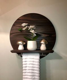 a towel rack with two white flowers on it