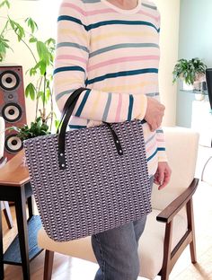 The outer material of this 13" x 13" x 2" handbag/tote is 100% hand woven cotton in a modified hucklace pattern that extends into the bag where you will find several slip pockets sewn into premium broadcloth for your phone, sunglasses, wallet, etc. There is also a large, full depth zippered pocket to safely store you belongings. The bag has a magnetic closure and is finished with 2 leather handles.  This is a one of a kind piece and would make the perfect gift for someone who loves unique handba Modern Crochet Tote Bag For Shopping, Crochet Tote Bag With Adjustable Strap, Everyday Woven Canvas Bag, Daily Use Woven Tote Satchel, Blue Crochet Bag With Double Handle For Everyday Use, Blue Double Handle Crochet Bag For Everyday Use, Everyday Woven Canvas Tote Bag, Modern Crochet Tote Bag With Leather Handles, Large Handwoven Bags For Everyday Use