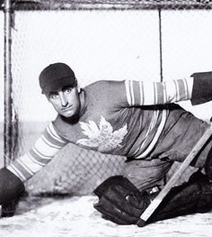 an old black and white photo of a hockey player