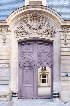 a purple door is open in front of a building