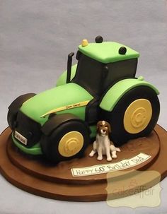 a cake with a tractor and dog on it