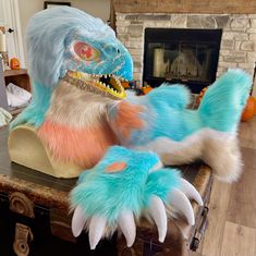 a large stuffed animal sitting on top of a wooden table next to a fire place