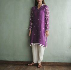 ✨KURTA Purple silk kurti has beautiful embroidered sleeves and small motifs all over front. ✨BOTTOM It has off white tulip pant ✨DUPPATA Off white chiffon dupatta with white scallop on all four sides. ✨This super trendy dress is perfect for party, semi casual look or festivals ✨We do not deal with replica.This is designers inspired customised outfit.These are all custom made dress as per our customers choice and measurements. ✨If you want any changes in the outfit people contact us we will guide White Cotton Silk Churidar With Long Sleeves, White Long Sleeve Kurta With Mirror Work, White Silk Kurta With Mirror Work, Unstitched Long Sleeve Kurta With Mirror Work, Long Sleeve Cotton Silk Salwar Kameez With Mirror Work, Spring Salwar Kameez With Mirror Work And Long Sleeves, Spring Long Sleeve Salwar Kameez With Mirror Work, Navratri Long Sleeve Lawn Suit With Mirror Work, Purple Silk Kurta With Chikankari Embroidery