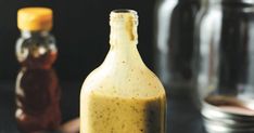 a bottle filled with mustard sitting on top of a table