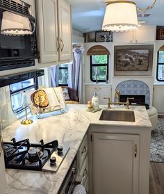 a kitchen area with a stove, sink and oven in it's center island