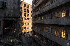 an old run down building with windows and balconies in the middle of it