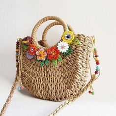 Handmade braided shoulder bag, with double handle and removable shoulder strap 1 meter long. Closure by cord. Inner lining with pocket.Decorated with acryl flowers that give it a very colorful touch, perfect to show off this summer!External dimensions in cm: 27 x 24 x 8 Care and maintenanceThis delicate piece has been created with a lot of dedication and love, and we hope it will become one of your favourites. Please, do not let it come into contact with water or other substances that can deteri Spring Flower Shoulder Bag With Adjustable Strap, Flower Shaped Shoulder Bag With Adjustable Strap For Spring, Summer Flower-shaped Bag With Adjustable Strap, Flower Shaped Bag With Adjustable Strap For Summer, Chic Summer Flower-shaped Bag, Chic Flower-shaped Summer Bags, Beige Flower-shaped Shoulder Bag For Beach, Spring Braided Shoulder Bag With Double Handle, Spring Braided Double Handle Shoulder Bag