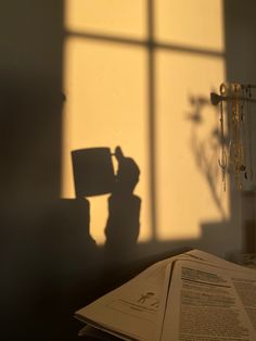 an open book sitting on top of a table next to a window