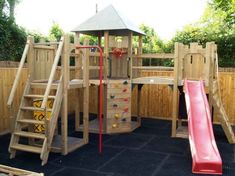 a wooden play structure with a slide and climbing wall