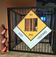 a jail gate with a sign that says in jail, just visiting on the inside