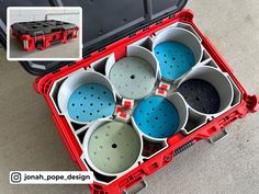 an open red case filled with lots of different colored pots