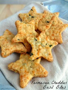 cheesy crackers with spinach and cheese are on a white cloth in a basket