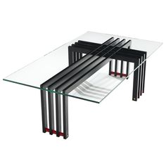 a glass table with four black metal legs