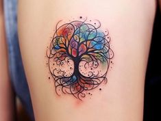 a colorful tree tattoo on the back of a woman's thigh, with circles and dots around it