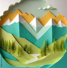 an origami mountain scene with trees and mountains